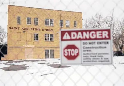  ?? MARK MIRKO PHOTOS/HARTFORD COURANT ?? The new owner of St. Augustine School says constructi­on on a conversion to apartments will resume in April or May. The Hartford Preservati­on Alliance placed the school, built in 1927, on its annual list of most endangered historic properties in the city for 2021.