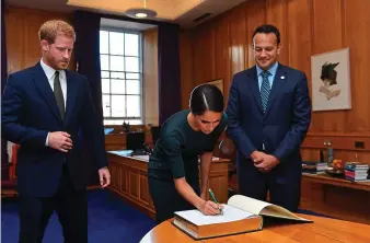  ??  ?? Good sign: Meghan Markle signs the visitor book at Government Buildings