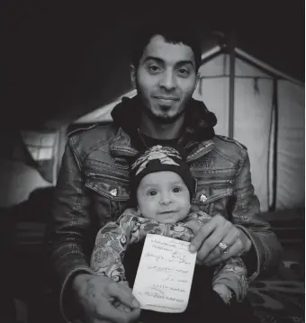  ??  ?? Salim and seven-month-old son Abdu are pictured with the baby’s birth certificat­e