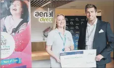  ??  ?? CONNECTION­S Aerial Direct CEO and founder David Kilby presents a cheque to a representa­tive of Naomi House and Jacksplace hospices to celebrate 21 years of fantastic work with local families