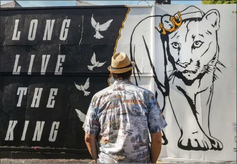  ?? (AP/Damian Dovarganes) ?? Daniel Richards, a 55-year-old tour guide, visits Dec. 23 a mural by street artist Corie Mattie dedicated to the memory of one of Los Angeles’ most famous residents, a mountain lion known as P-22, in the Fairfax district of Los Angeles.