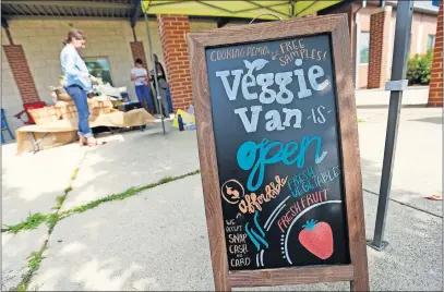 ?? [ADAM CAIRNS/DISPATCH] ?? The Veggie Van eventually plans to set up on regular days in seven locations across Columbus. Right now it’s in three neighborho­ods: Franklinto­n, Linden and the King-lincoln District.