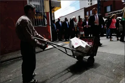  ?? Matt McClain/The Washington Post ?? U.S. Sen. Bernie Sanders, I-Vt., in line, greets people in San Francisco’s Chinatown during his 2016 presidenti­al campaign.