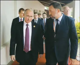  ?? AP PHOTO ?? President Vladimir Putin, left, and Russian metals magnate Oleg Deripaska walk to attend the APEC Business Advisory Council dialogue in Danang, Vietnam.