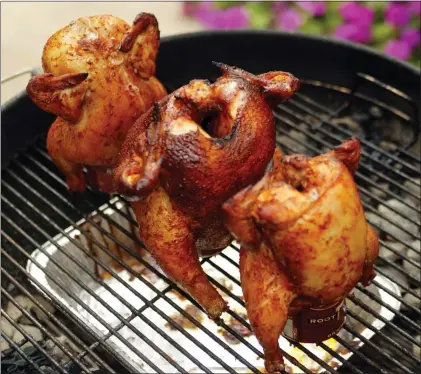  ?? STAFF FILE PHOTOS ?? Beer cans are both grilling utensils and flavor enhancers in the backyard barbecue classic beer can chicken.