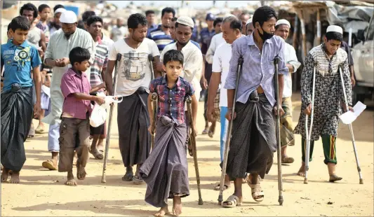  ?? Picture: AP/African News Agency (ANA) ?? Wounded Rohingya refugees on crutches await the arrival of a UN Security Council team at the Kutupalong Rohingya refugee camp in Bangladesh, yesterday.