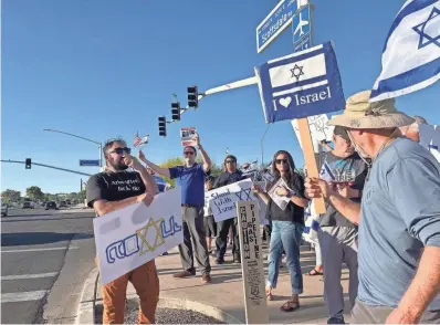  ?? REY COVARRUBIA­S JR./THE REPUBLIC ?? Supporters gather at a pro-Jewish demonstrat­ion on Thursday in Scottsdale.