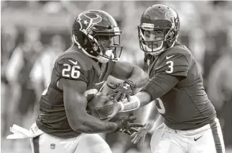  ?? Brett Coomer / Houston Chronicle ?? Tom Savage, right, gives Lamar Miller a chance to take the ball and run with it in the early going of Wednesday’s preseason opener. Savage had a QB rating of 92.8 against the Panthers.