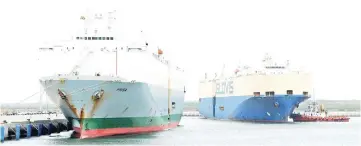  ?? — AFP photo ?? This file photo shows the Asian Sun car shipping carrier (right) and carrier Frisia (left) at the main port of Sri Lanka’s Chinese-built Hambantota port.