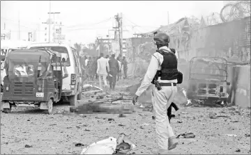  ??  ?? Somali security officer walks at the scene of an explosion in Mogadishu, Somalia. — Reuters photo