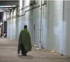  ?? PAT MCDONOGH/COURIER JOURNAL ?? A homeless man walked along Jefferson Street under the I-65 overpass in Louisville on Jan. 30, 2020.