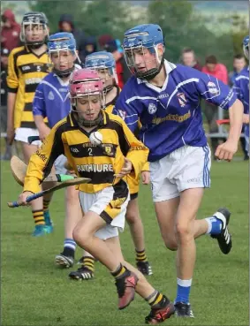  ??  ?? Rathnure defender Eoin O’Neill is pursued by Jack Hennessy.