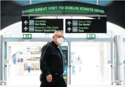  ?? PHOTO: BRIAN LAWLESS/PA ?? Prayer miles: A priest wearing a protective face mask at Terminal 2 in Dublin Airport.