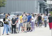  ?? GERALD HERBERT — THE ASSOCIATED PRESS ?? People line up to enter retail chain Costco to buy provisions Aug. 23 in New Orleans in advance of Hurricane Marco, expected to make landfall on the Southern Louisiana coast.