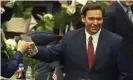  ??  ?? DeSantis fist bumps a legislator in Tallahasse­e on 2 March. Photograph: Phil Sears/ AP