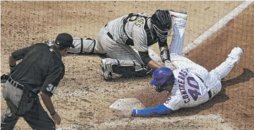  ?? NAM Y. HUH/AP ?? Cubs baserunner Willson Contreras scores on a double by Kyle Schwarber in the fifth inning Sunday against the Pirates.