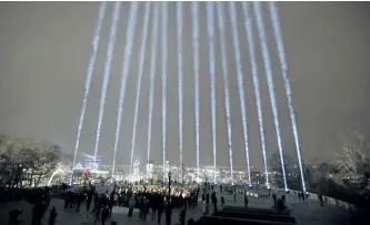  ?? RYAN REMIORZ/THE CANADIAN PRESS ?? Fourteen beams of light shine toward the sky during a ceremony Wednesday marking the 28th anniversar­y of the Montreal Massacre on Dec. 6, 1989.