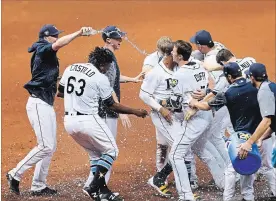  ?? CHRIS URSO TAMPA BAY TIMES ?? Tampa Bay players celebrate after Rays centre-fielder Mallex Smith scored on third baseman Matt Duffy’s walk-off base hit to end the game 1-0 against the Toronto
Blue Jays on Wednesday afternoon in St. Petersburg, Fla.