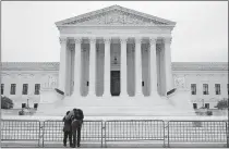  ?? SEMANSKY/ THE ASSOCIATED PRESS] ?? A woman and man pray outside the Supreme Court on Tuesday on Capitol Hill in Washington, the day after the Senate confirmed Amy Coney Barrett to become a Supreme Court Justice. [PATRICK