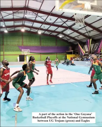  ?? ?? A part of the action in the ‘One Guyana’ Basketball Playoffs at the National Gymnasium between UG Trojans (green) and Eagles