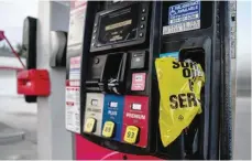  ?? — AFP ?? Out of order notes are left on gas pumps to let motorists know the pumps are empty at a gas station in Hollywood.