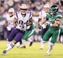  ?? ADAM HUNGER/ASSOCIATED PRESS ?? New England Patriots tight end Benjamin Watson runs past New York Jets’ Blake Cashman on Monday in East Rutherford, N.J.