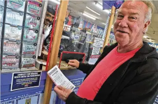  ?? BILL LACKEY/STAFF ?? David Griffin buys his Powerball tickets Thursday at the Plum Food Mart in Springfiel­d. Without a winner last Wednesday, the Powerball jackpot is $800 million.