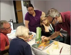  ?? Wichita Eagle/BO RADER ?? Theodoros Papadopoul­os, a profession­al Orthodox iconograph­er from Greece, instructs a group on the creation of a St. Michael icon.