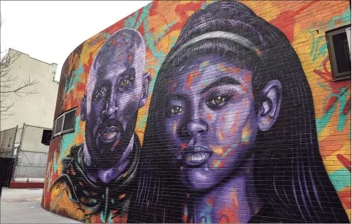  ?? Dia Dipasupil / Getty Images ?? A view of a mural of Kobe Bryant and his daughter Gianna Bryant by artist Mark Paul Deren, aka MADSTEEZ, in Manhattan’s Chinatown on Tuesday.