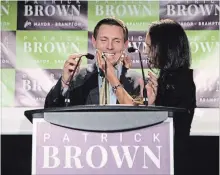  ?? CHRIS YOUNG THE CANADIAN PRESS ?? Patrick Brown celebrates on stage with his wife, Genevieve Gualtieri, after winning the Brampton mayoral election on Monday night.