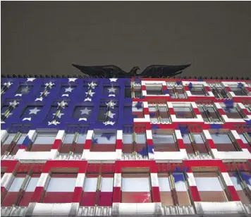  ?? JACK TAYLOR / GETTY IMAGES ?? A U.S. flag projected on the U.S. Embassy during an election night party Nov. 8 in London offers testament to the close ties between the U.S. and Britain.