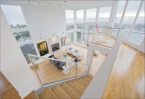  ?? PHOTOS: FRANCES LITMAN VICTORIA TIMES COLONIST ?? The renovated living room has 18-foot ceilings and an upper balcony that juts out like a crow’s nest on a ship – offering a great spot to watch the sun set.