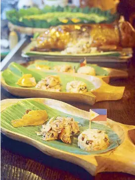  ?? Photos courtesy of Nicky Lozano ?? Dedet de la Fuente’s Pepita’s Kitchen specialty, lechon with truffle rice, was served in wooden pig plates brought all the way from the Philippine­s.