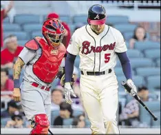  ??  ?? First baseman Freddie Freeman, whose home run tied the game in the eighth inning, strikes out in the 14th inning in the loss to the Cards.