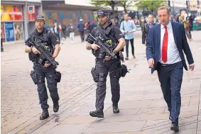  ?? EMILIO MORENATTI/ASSOCIATED PRESS ?? Police officers patrol in central Manchester, England, on Wednesday after Monday’s suicide attack at an Ariana Grande concert which killed 22 people..