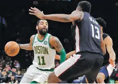  ??  ?? ELISE AMENDOLA/AP Boston Celtics guard Kyrie Irving (11) makes a move against Washington Wizards center Thomas Bryant during the first quarter of an NBA basketball game on March 1, 2019 in Boston.