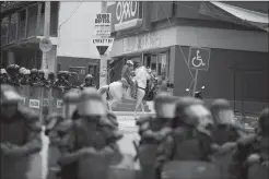  ?? Associated Press ?? A man on horseback rides past scores of police and soldiers surroundin­g the office of the National Electoral Institute, during a protest by members of a teachers union in Chilpancin­go, Guerrero State, Mexico, on Friday. The confrontat­ion ended...