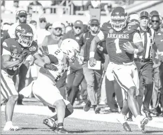  ?? Submitted Photo ?? Razorback quarterbac­k KJ Jefferson (#1) from Sardis, Miss., runs for a first down against Penn State at the Outback Bowl earlier this year at Raymond James Stadium in Tampa, Fla. Jefferson will be signing autographs at Armor Bank in Forrest City on Thursday next week.