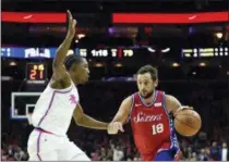  ?? MICHAEL PEREZ — THE ASSOCIATED PRESS ?? Marco Belinelli, right, drives to the basket past Miami’s Josh Richardson Wednesday night. Belinelli scored 17 points in his Sixers debut, a 104-102 win over the Heat.