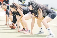  ??  ?? Coach Ichtar Zahraoui (right) trains members of ‘The Pirates’ American football team in the Moroccan capital Rabat. — AFP photo