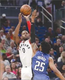  ?? The Associated Press ?? Toronto Raptors’ CJ Miles shoots over Orlando Magic’s Wesley Iwundu during first-half NBA action on Tuesday in Orlando, Fla. The Raptors won 93-86.