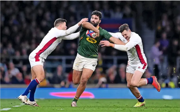  ?? PICTURE: Laurence Griffiths/getty Images ?? Damian de Allende, pictured being tackled by England’s Ben Youngs and Jonny May for South Africa in November, has categorica­lly ruled out a move to Bath