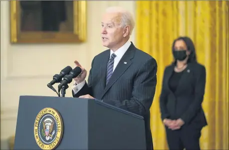  ?? ANDREW HARNIK — THE ASSOCIATED PRESS ?? President Joe Biden speaks about COVID-19vaccinat­ions, from the East Room of the White House, Thursday, March 18, in Washington, as Vice President Kamala Harris listens.