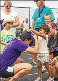  ?? SUBMITTED ?? Anytime Fitness member Ashley Zuchelli earns her finisher’s medal from one of this year’s 24 in 24 Challenge recipients, Mya, on July 24 at Riverside Campus.