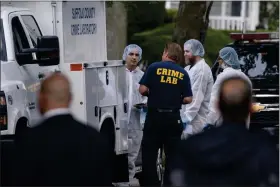  ?? EDUARDO MUNOZ ALVAREZ — THE ASSOCIATED PRESS ?? Crime laboratory officers arrive to the house where a suspect has been taken into custody on New York’s Long Island in connection with a long-unsolved string of killings, known as the Gilgo Beach murders, Friday, July 14, 2023, in Massapequa, N.Y.