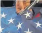  ??  ?? Michael Neel of All Veterans Funeral & Cremation cuts out stars from a retired, donated American flag to be used on death certificat­es.