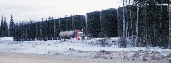  ?? SHEILA PRATT/Postmedia News photos ?? A truck pulls up for a load of hot bitumen from tanks near Peace River, Alta. A thick mixture of oil and sand is pumped into the tanks from wells below.