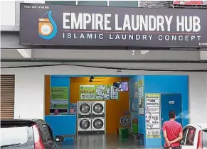  ??  ?? Not for all: The green sign on the left inside the launderett­e in Kangar, Perlis, states that it is for Muslims only.