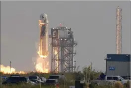  ?? TONY GUTIERREZ — THE ASSOCIATED PRESS ?? Blue Origin’s New Shepard rocket launches carrying passengers Jeff Bezos, founder of Amazon and space tourism company Blue Origin, his brother Mark Bezos, Oliver Daemen and Wally Funk, from its spaceport near Van Horn, Texas, on Tuesday.