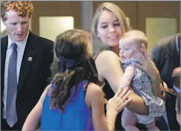  ?? Elise Amendola Associated Press ?? ‘SHE LIT UP OUR LIVES’ Saoirse Kennedy Hill holds a relative’s baby in 2016. At left is U.S. Rep. Joseph P. Kennedy III (D-Mass.). Hill, who had a history of depression, died at age 22 at the family compound in Hyannis Port, Mass.